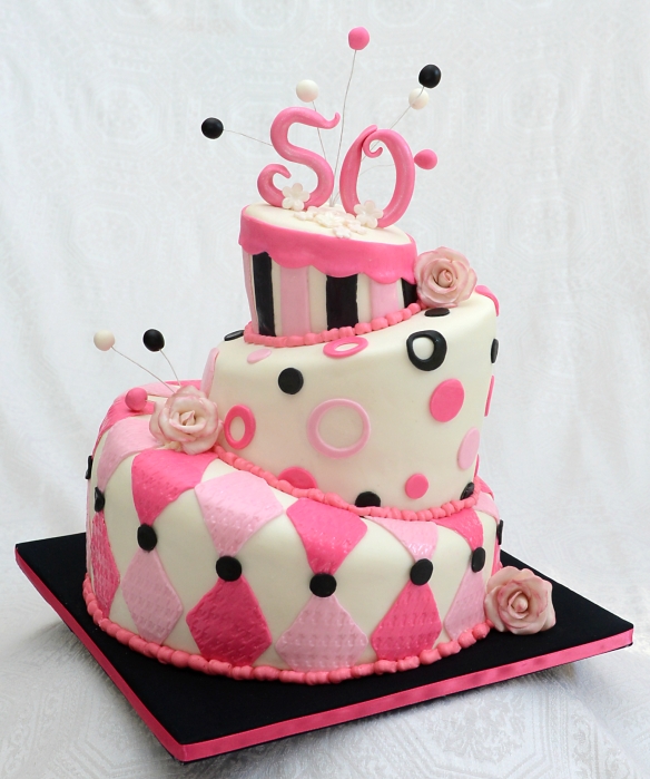 Gâteau ''Topsy Turvy'' 3 étages pour un 50e anniversaire. 2 étages à la vanilla et 1 au chocolat avec glaçage meringue Suisse à la vanille et recouvert de fondant